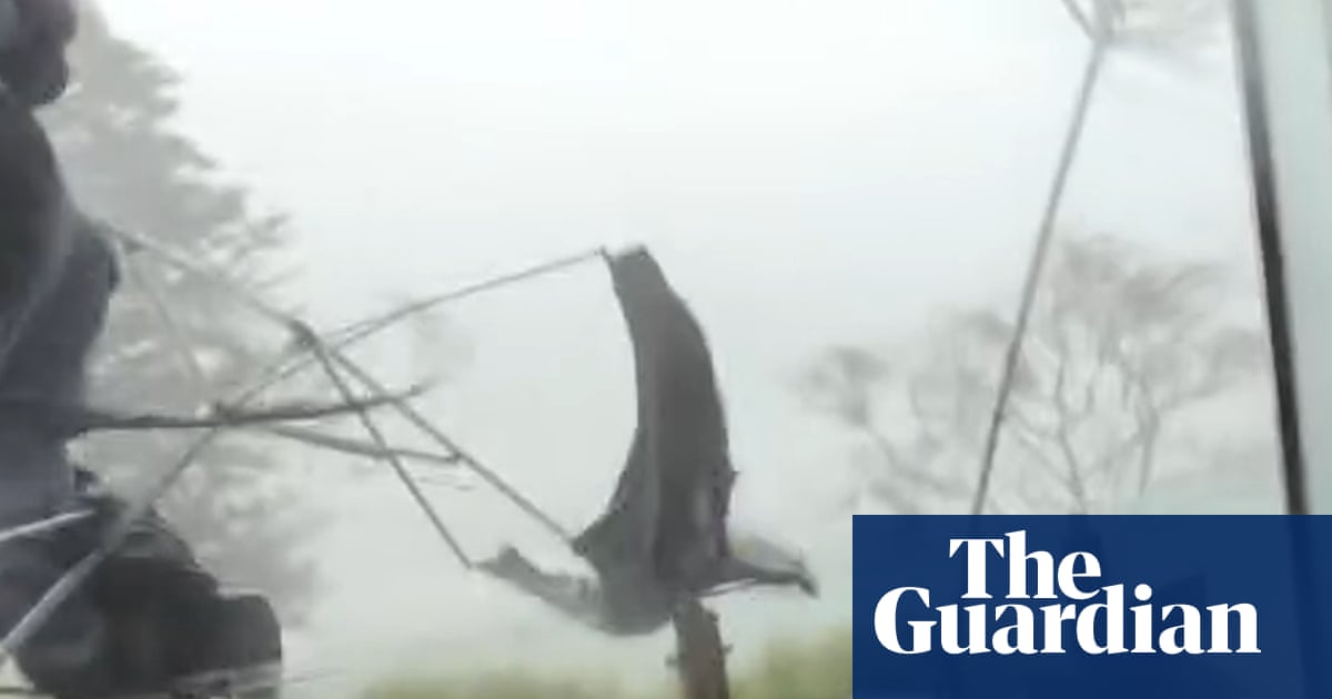 High winds sweep away tables and chairs outside New South Wales cafe – video | Australia weather