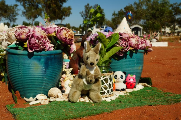A close of flowers and soft toys