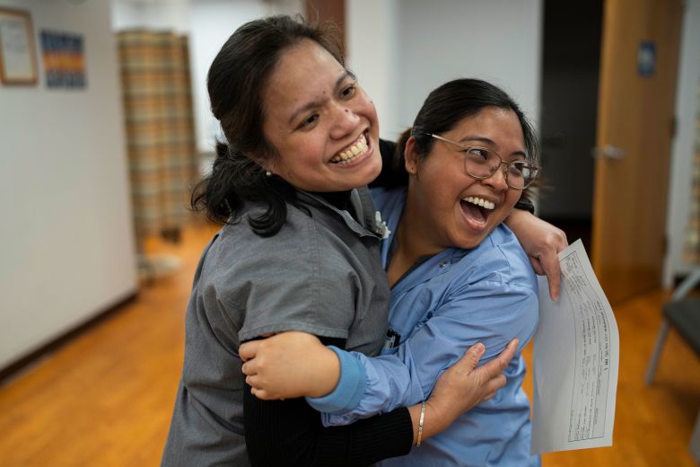 Marichu shares a hug with a colleague at the West River Hospital in between ultrasound appointments.