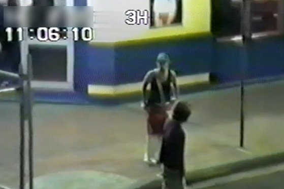 image grab from cctv footage of a young woman wearing a cap talking to a young male outside a hotel in lismore
