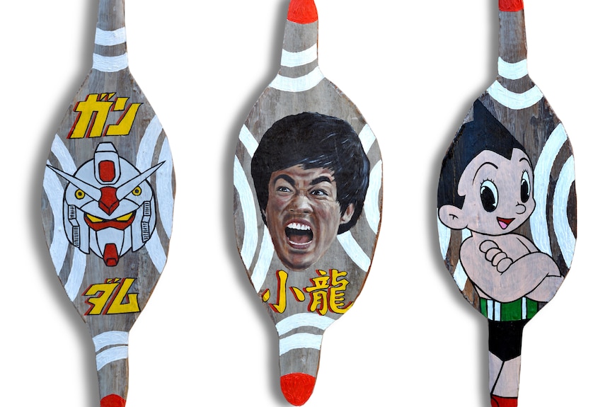 Three warrior's shields painted with asian pop culture 
