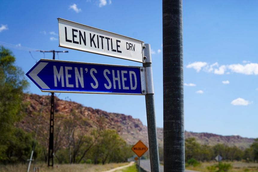 Street signs reading 'Len Kittle Drive' and 'Men's Shed'.
