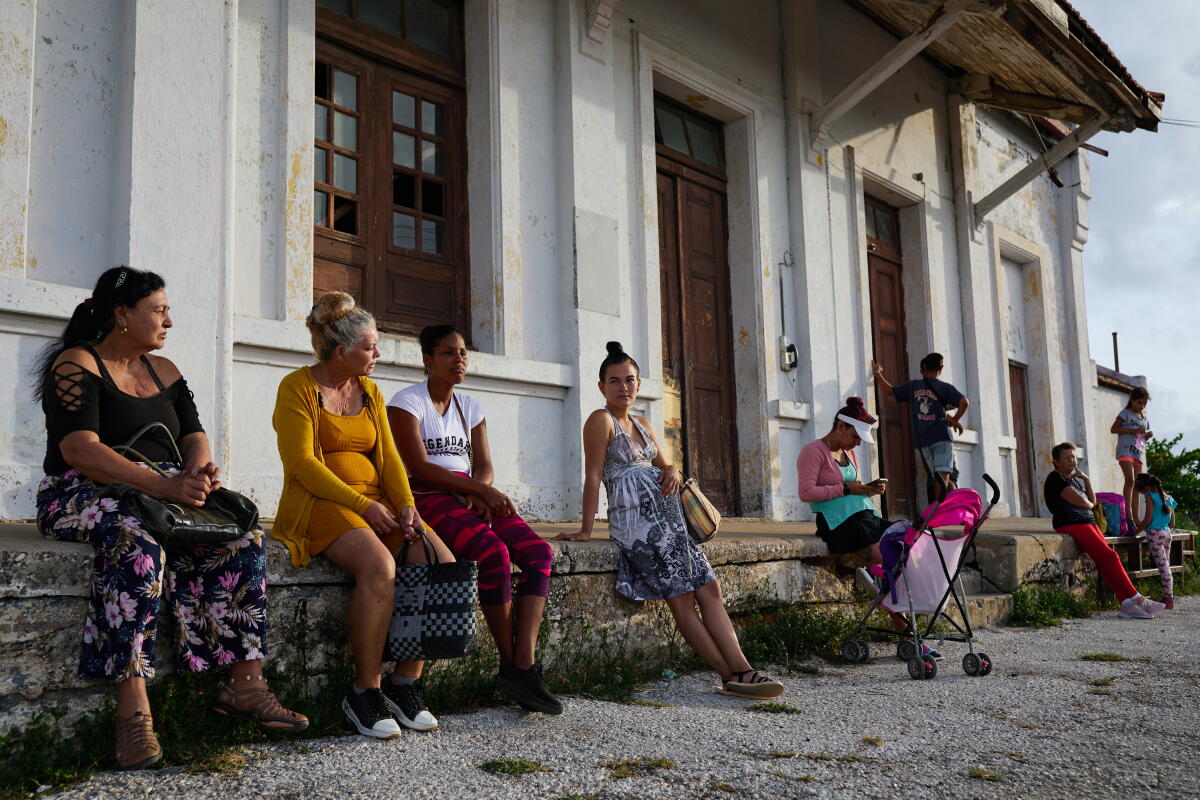 A woman waits for a bus. 