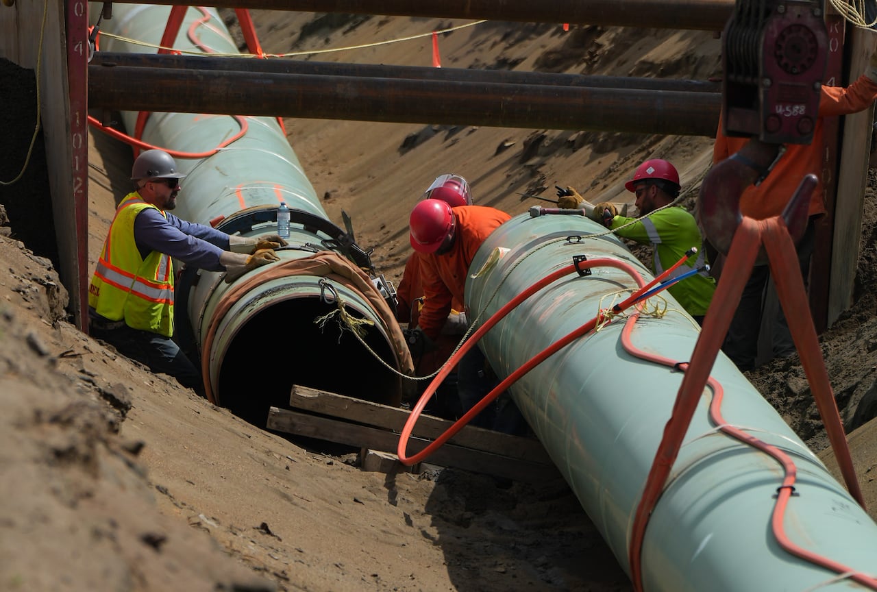 This image shows a close up of two sections of the Trans Mountain pipeline being assembled.