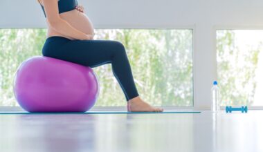 Pregnant woman balancing on exercise ball.