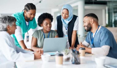 Teamwork, planning and meeting with doctors and laptop for medical, review and healthcare. Medicine, technology and internet with group of people for collaboration, diversity and support in hospital