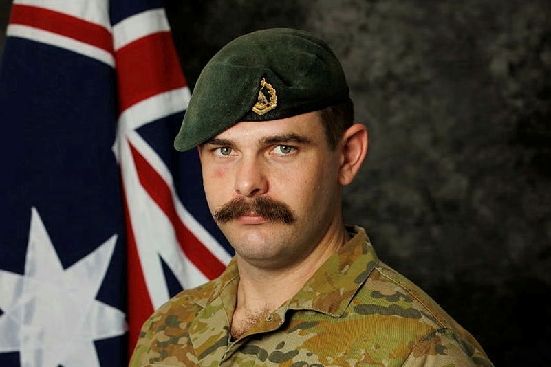 Corporal Brendan Hannam wears a serious facial expression while dressed in his army uniform.
