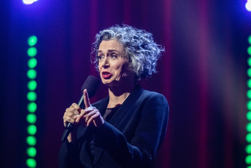 Comedian Judith Lucy performing stand-up on stage at Just For Laughs.