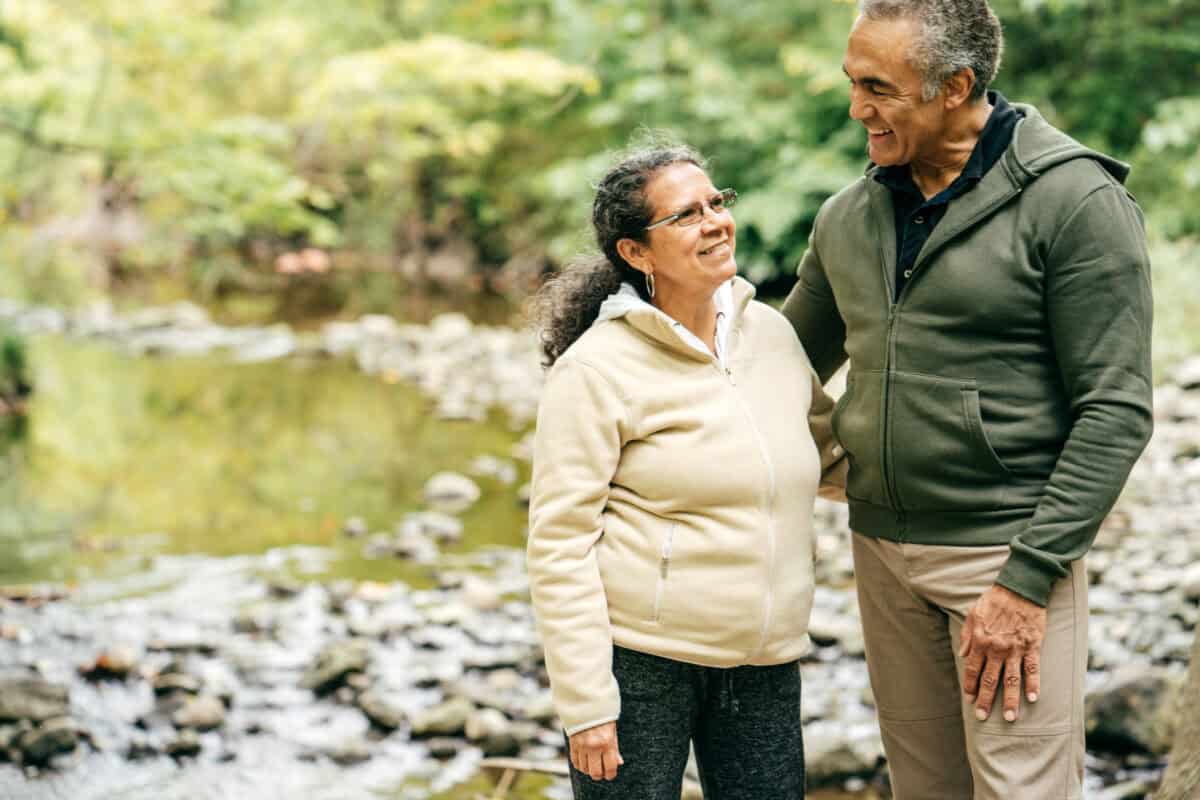 Two seniors walk in the forest