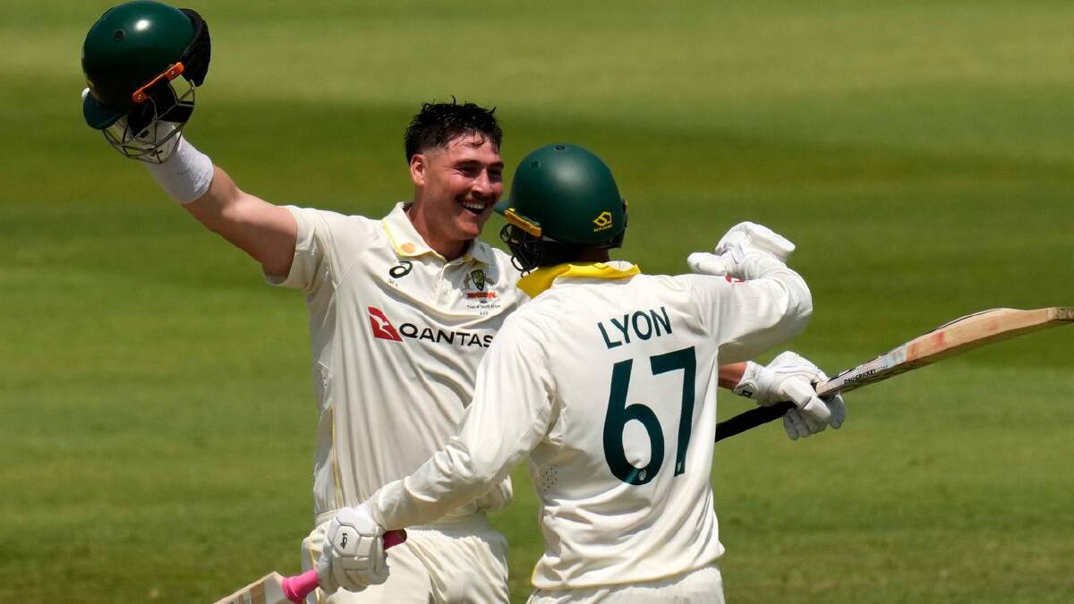 Nathan Lyon rushes to congratulate Matt Renshaw after he reached his century in Durban. (AP PHOTO)