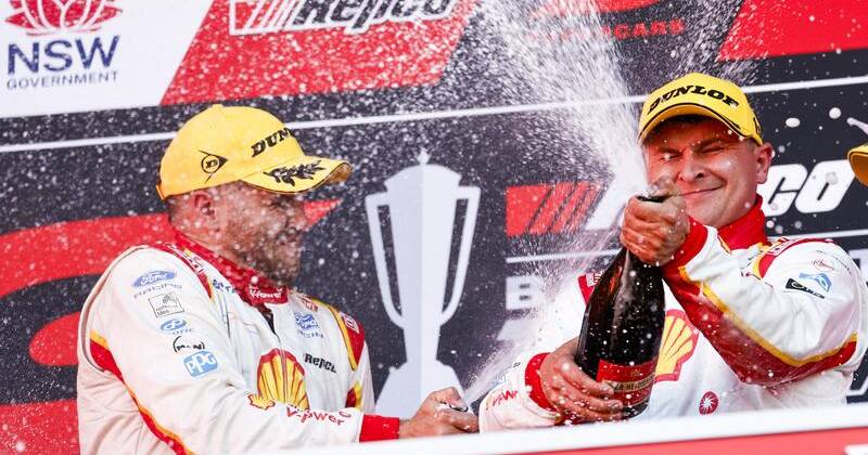Brodie Kostecki (l) and Todd Hazelwood (c) celebrate their Bathurst 1000 triumph. Photo: Mark Evans/AAP PHOTOS