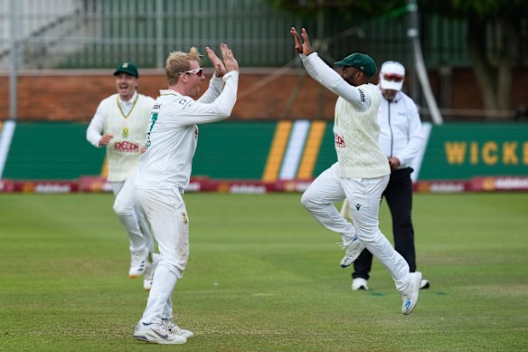 South Africa’s Simon Harmer and Temba Bavuma celebrate the wicket of Marnus Labuschagne.