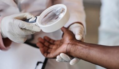 Clinician looking at skin of African American individual