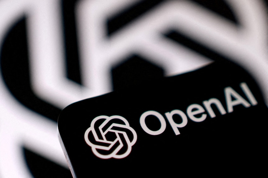 A white logo with white text on the top of a black screen, with the same logo blurred in the background
