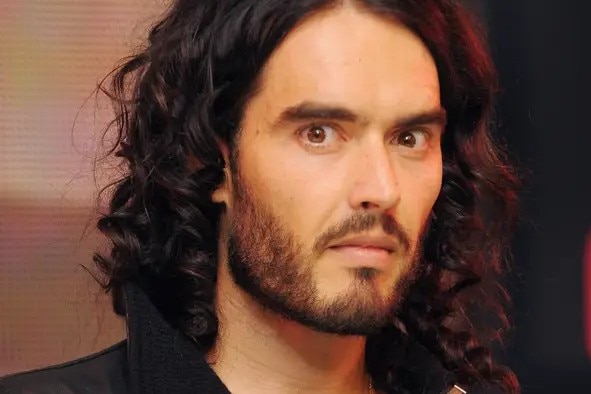 A man looking at the camera with a serious expression.