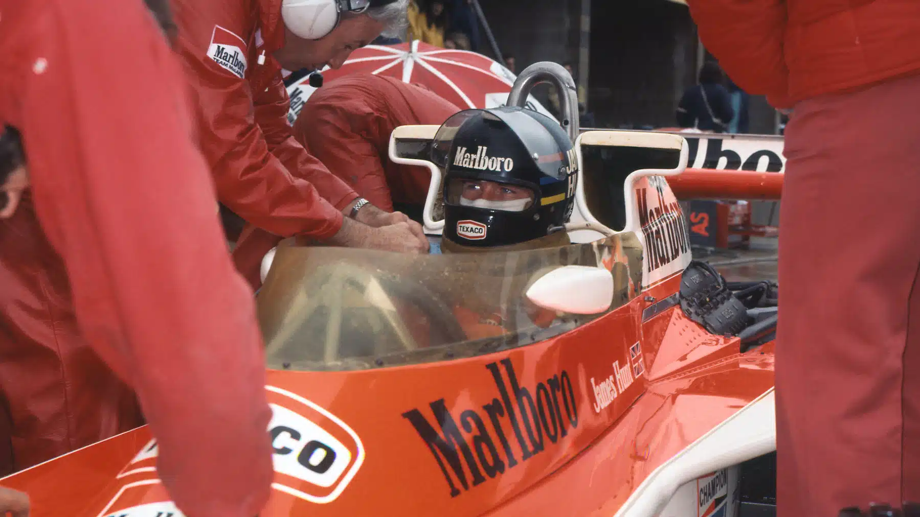 James Hunt and McLaren-Mercedes team princial Teddy Meyer in the pits during wet practice for the 1976 United States Grand Prix in Watkins Glen