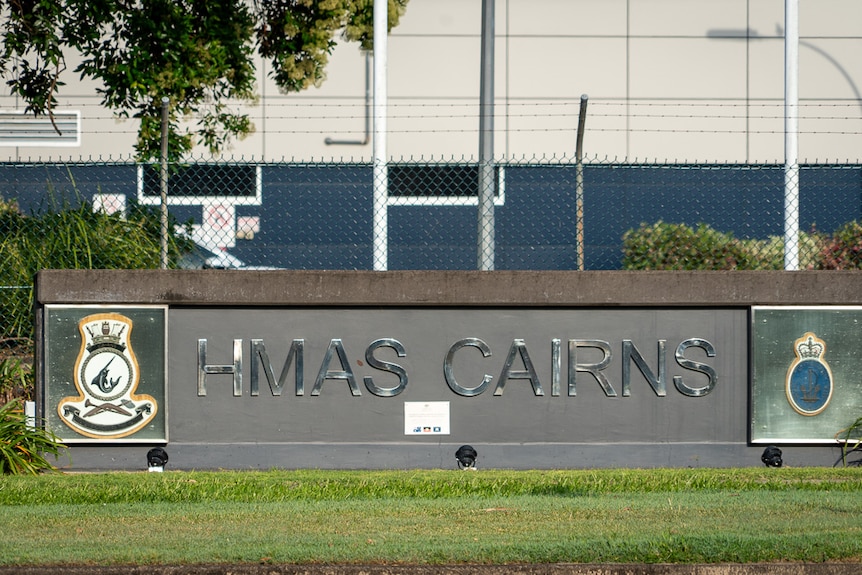 Photo of a sign reading "HMAS CAIRNS".
