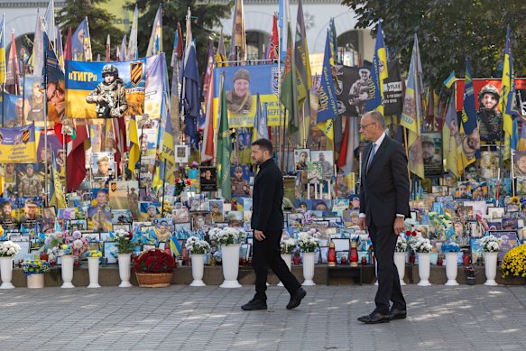Ukrainian President Volodymyr Zelensky and German Chancellor Friedrich Merz at a memorial for Ukrainian soldiers in Kyiv on Sunday.