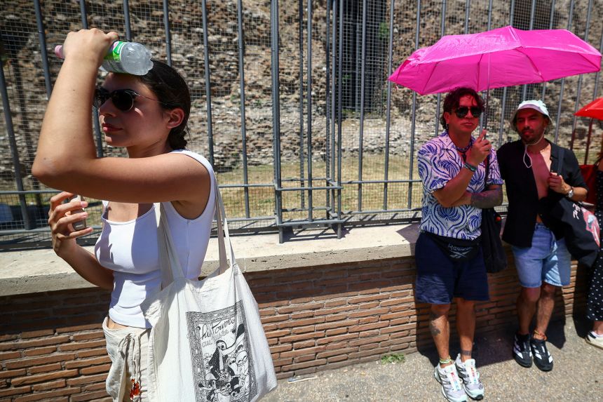A tourist attempts to cool down near the Colosseum during a heatwave in Rome, Italy, on June 20.