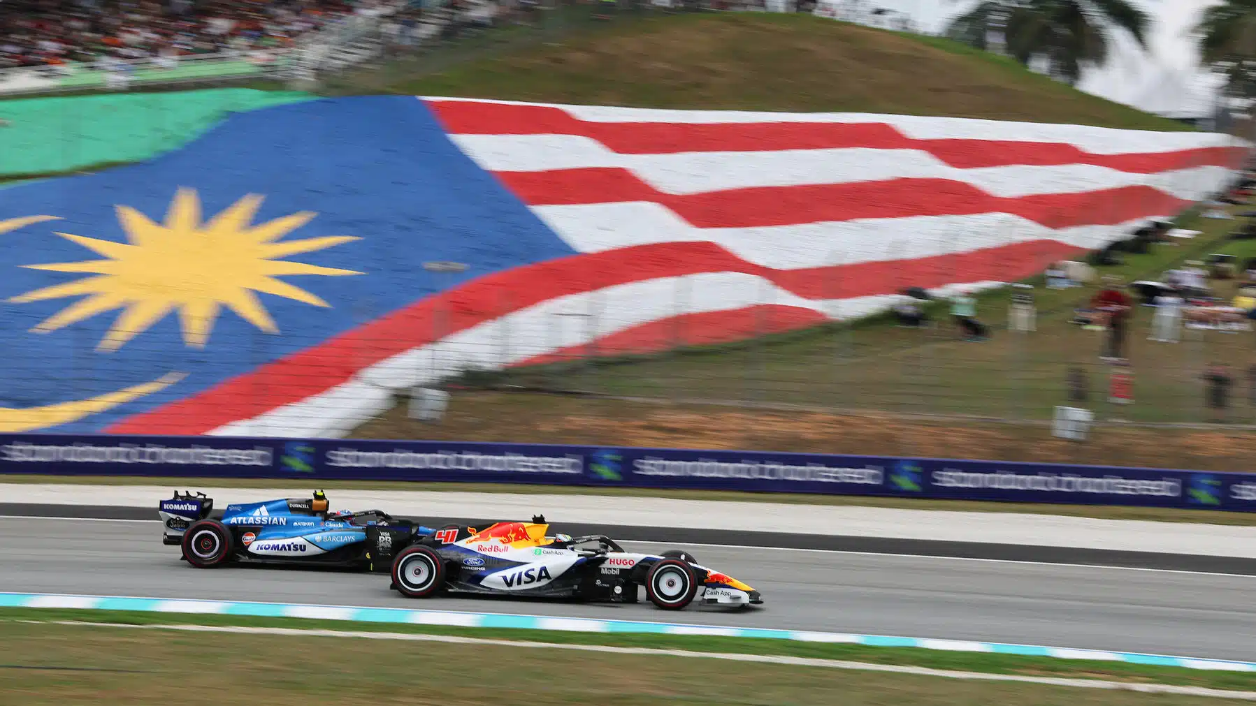 Arvid Lindblad (Racing Bulls-Ford) and Carlos Sainz Jr (Williams-Mercedes) during FP3 practice for the 2026 Bahrain Grand Prix
