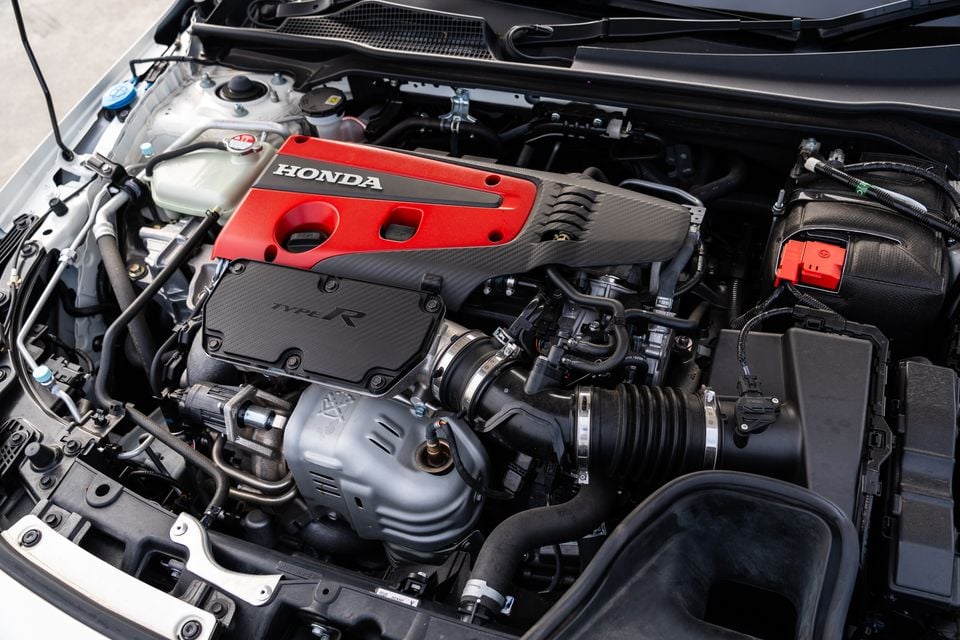 Honda Civic Type R engine bay showing the red and carbon-fibre engine cover with Honda and Type R badging