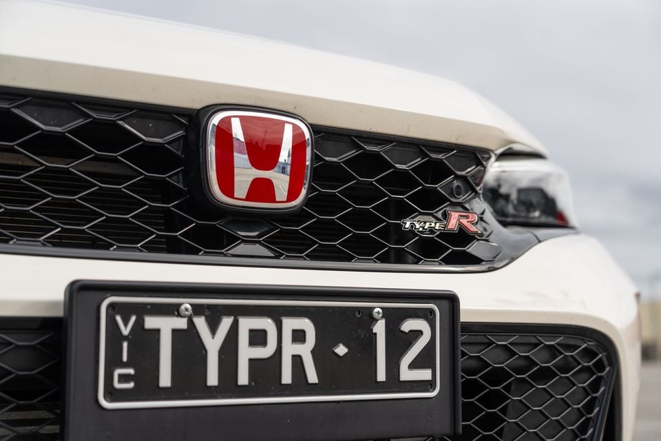 Close-up of the front grille and Honda badge on a white Honda Civic Type R, with a Victorian number plate reading TYPR 12