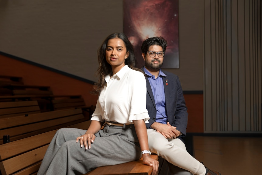 Manisha Caleb and Themiya Nanayakkara in a physics lecture hall.