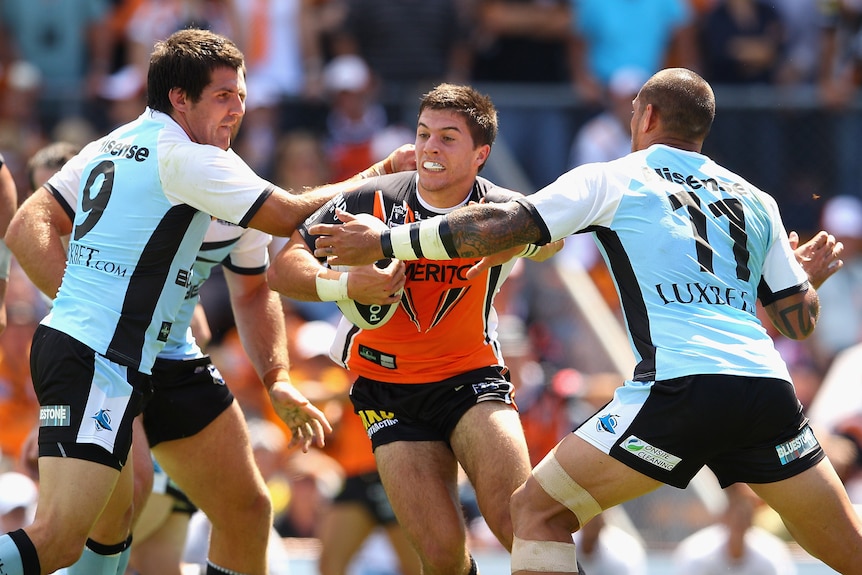 A man runs the ball during a rugby league match 
