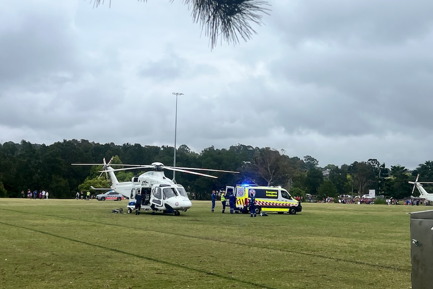 Helicopter on an oval with ambulance