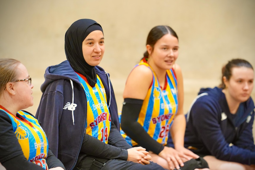 Reema El Qassem sits among a few of her teammates as they watch the action off camera.