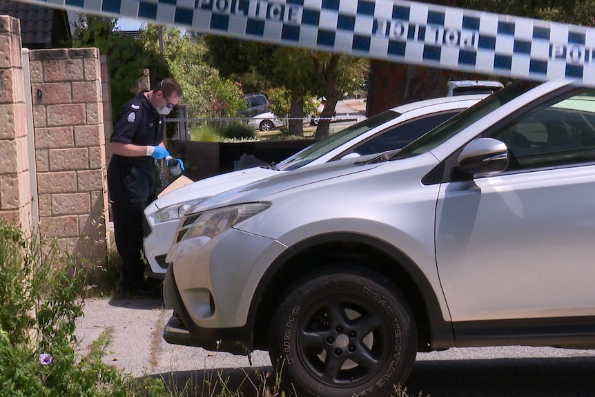 Forensic police officers working at the scene of a home that was shot at. 
