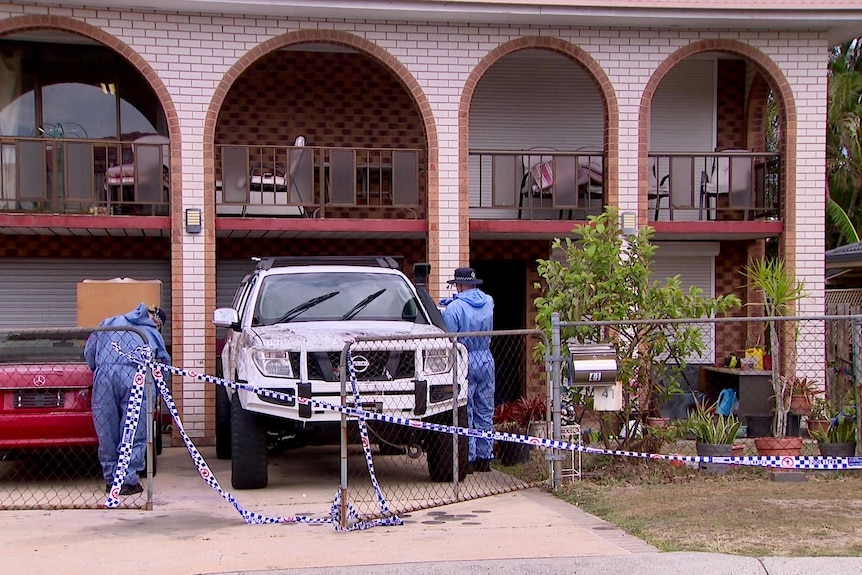 forensice officers at a house cordoned off with police tape