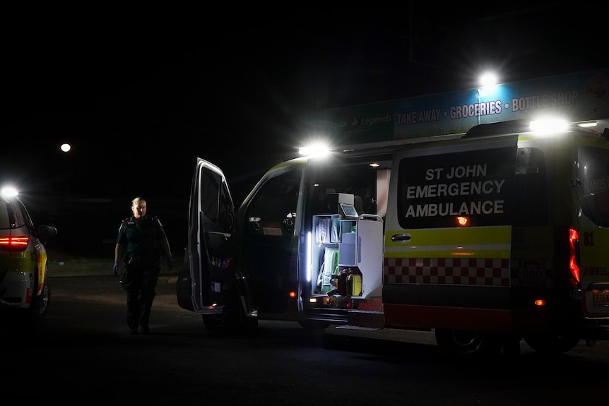 A parked ambulance with its side door open 