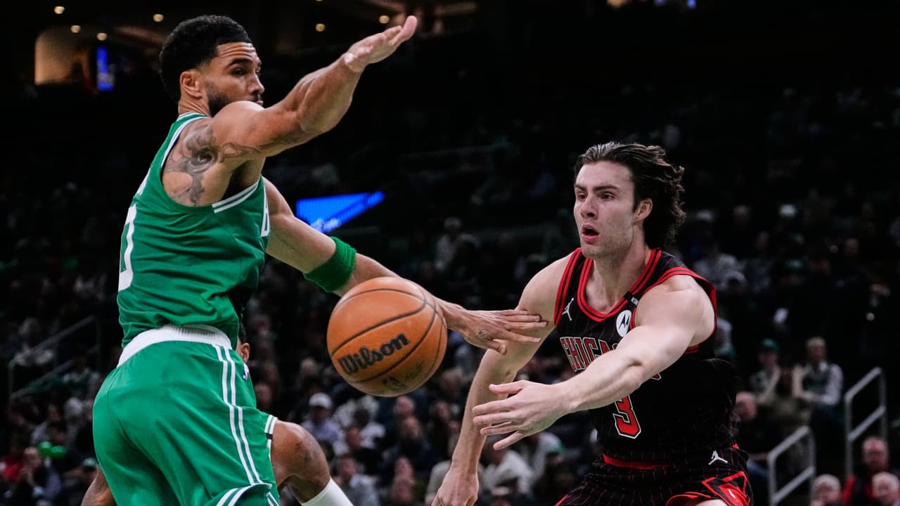 Chicago Bulls' Josh Giddey, right, passes the ball while pressured by Boston Celtics' Jayson Tatum, left, during the first half of an NBA basketball game, Monday, Oct. 26, 2026, in Boston. (AP Photo/Charles Krupa)