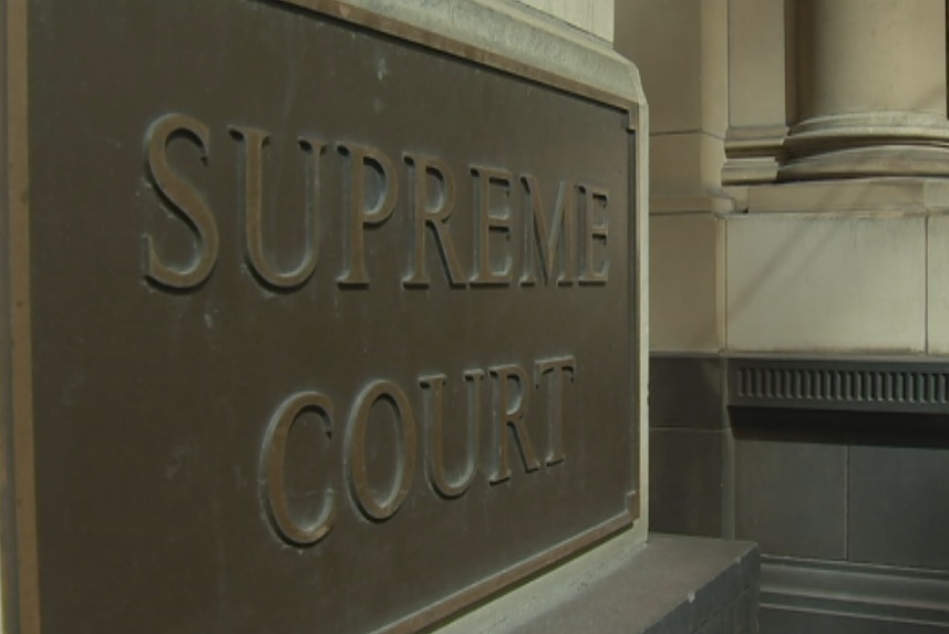 A picture of a court house sign that reads Supreme Court