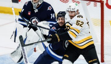 Sean Kuraly (right) is tangled up with the Jets' Dylan DeMelo during the Bruins 4-3 overtime win over the Jets on Friday night.