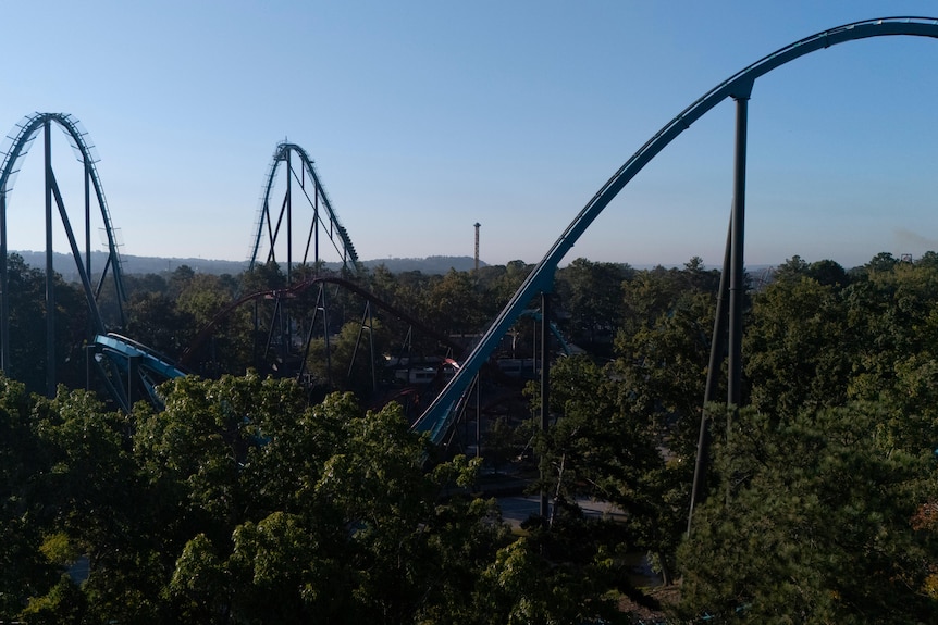 An aerial view of attractions at Six Flags over Georgia. The ground is covered in trees.