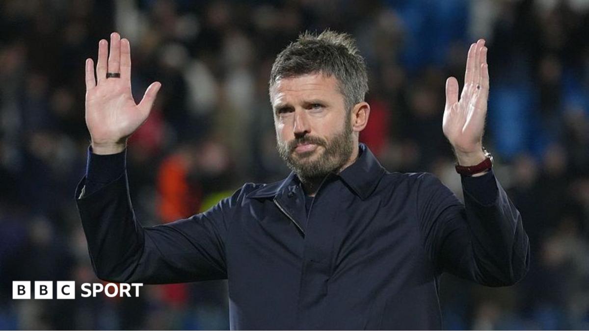 Manchester United manager Michael Carrick making a gesture of apology to fans
