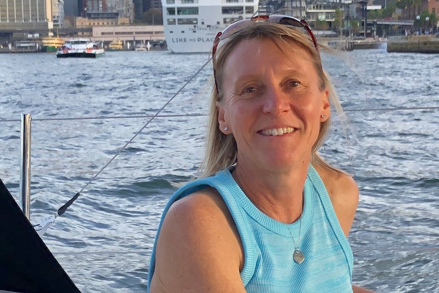 Christine La Rose sits on a boat and smiles at the camera.