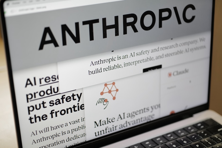 Pages from the Anthropic website and the company's logo are displayed on a computer screen.