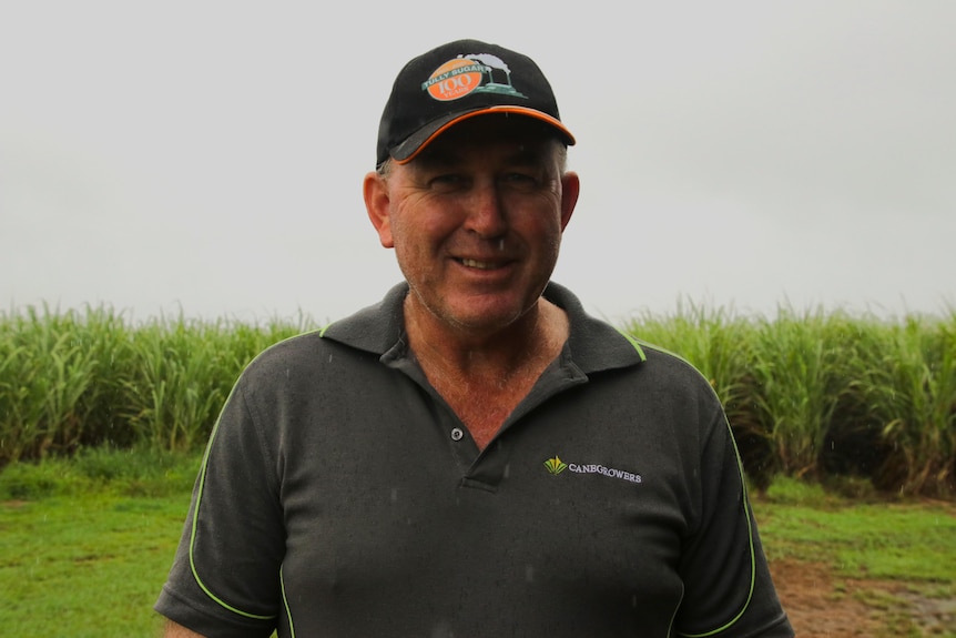 Headshot of sugarcane farmer Bryce MacDonald in front of his sugarcane on a rainy day.