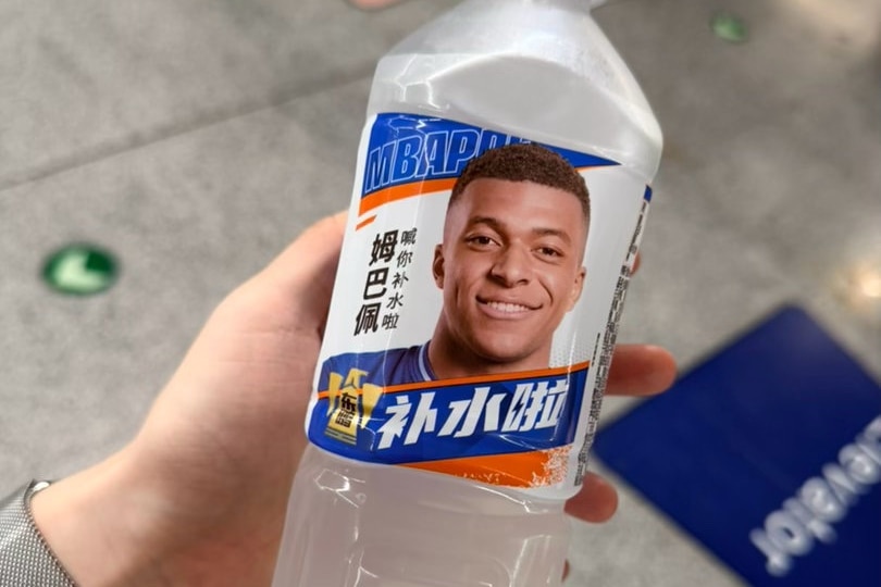 A white plastic bottle with a label featuring a portrait of a man.