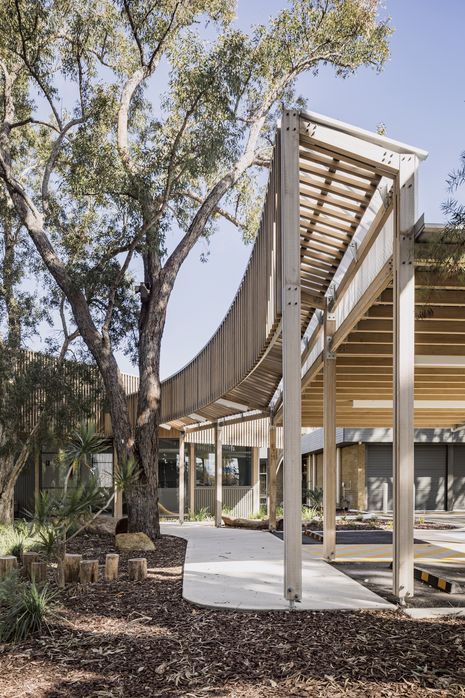 The restrained, low-slung pavilion structure responds to the surrounding natural setting.