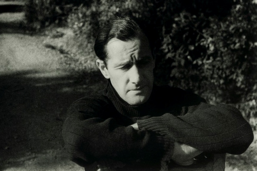Australian artist Sidney Nolan pictured in a black and white photograph.