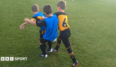 Three children playing 3v3 football