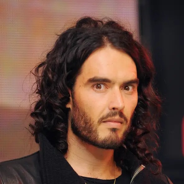 A man looking at the camera with a serious expression.