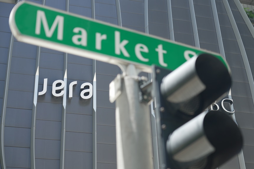 A street sign in front of a tall building