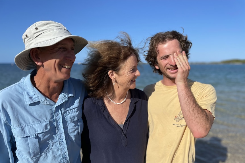 A close image of an adult man with his mother and father