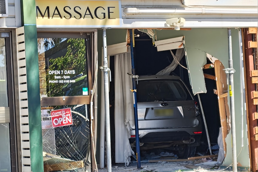 A car in a shop that is damaged.