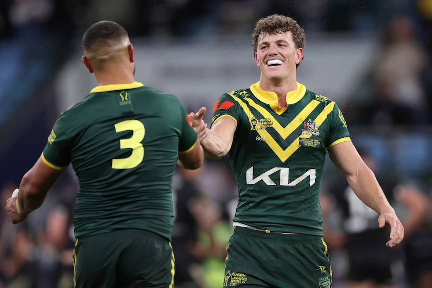 Two men celebrate winning a rugby league match